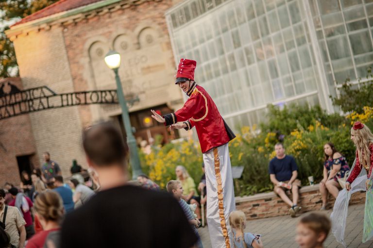 A street performer dressed as a toy soldier on stilts.