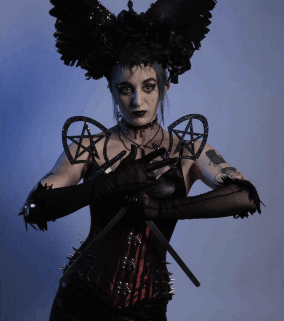 Gothic costume with dark makeup and headdress.