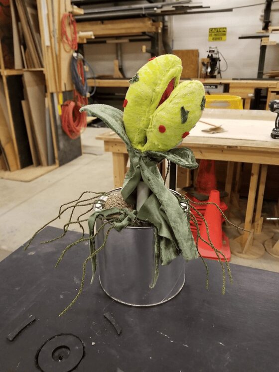 Fake plant resembling Venus flytrap in workshop.