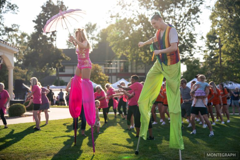 Colorful stilt walkers at outdoor festival
