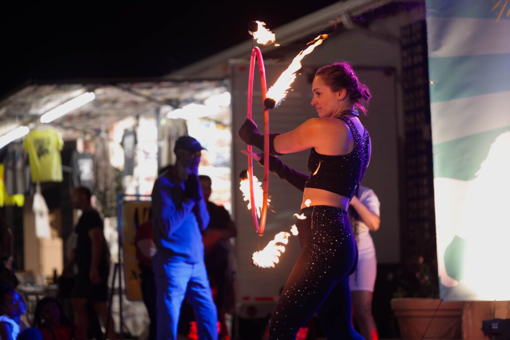 Performer twirling flaming hula hoop