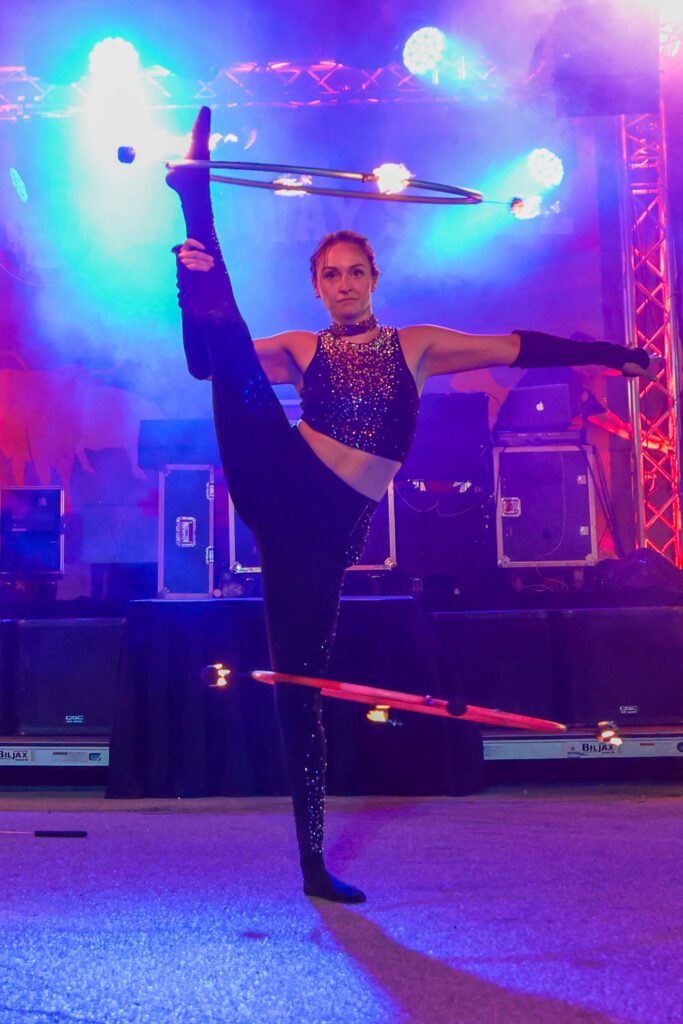 Circus performer balancing hula hoops on stage