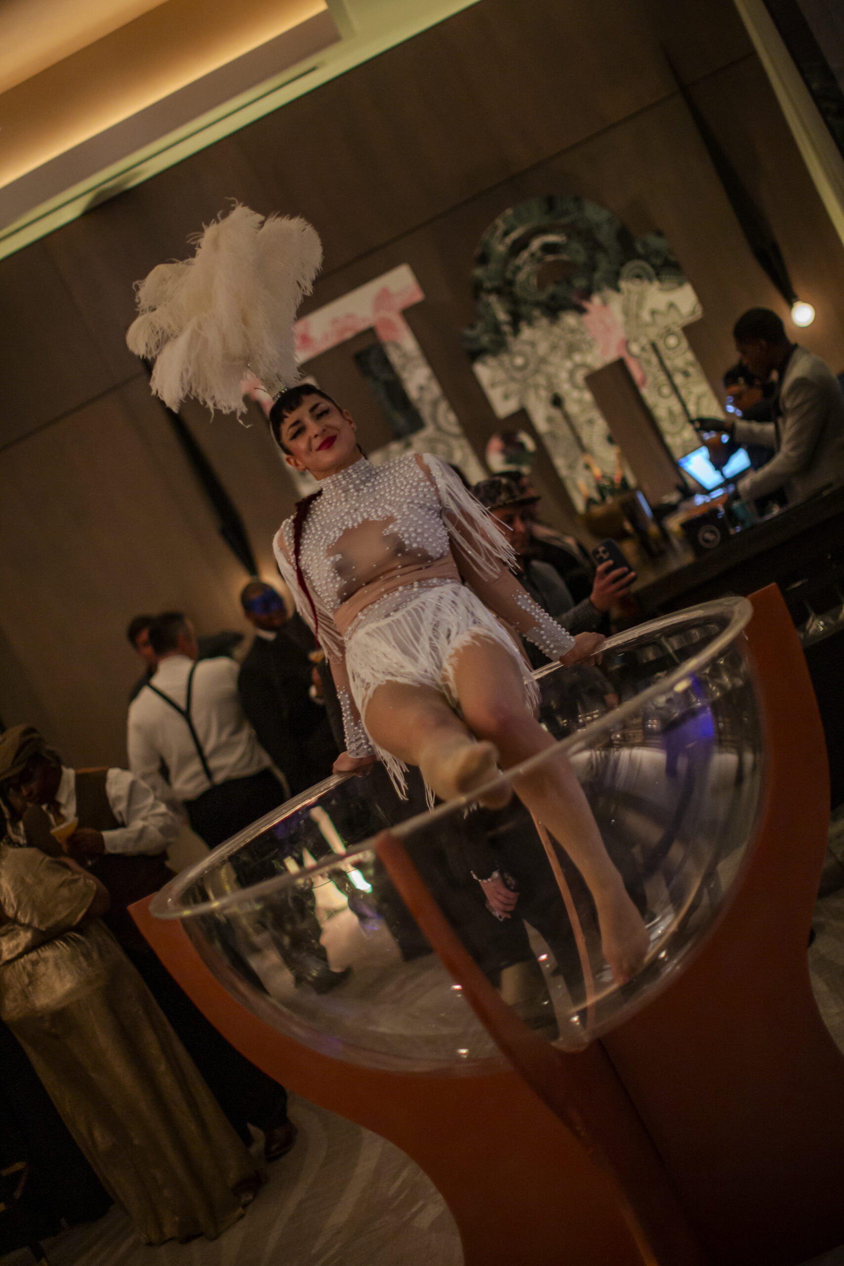 Burlesque performer in giant champagne glass
