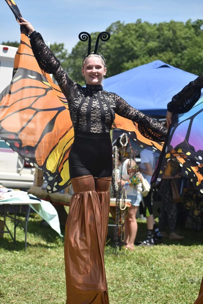 Stilt walker in monarch butterfly costume