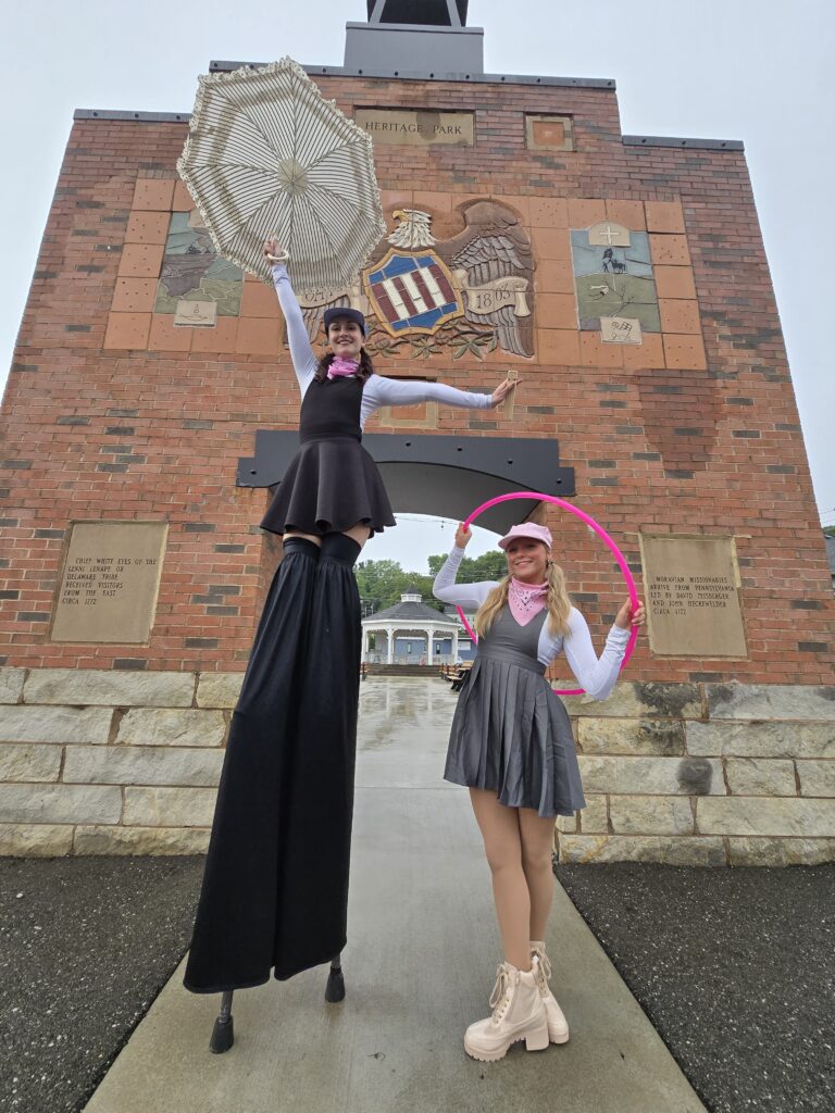 Stilt walker and hula hoop performer