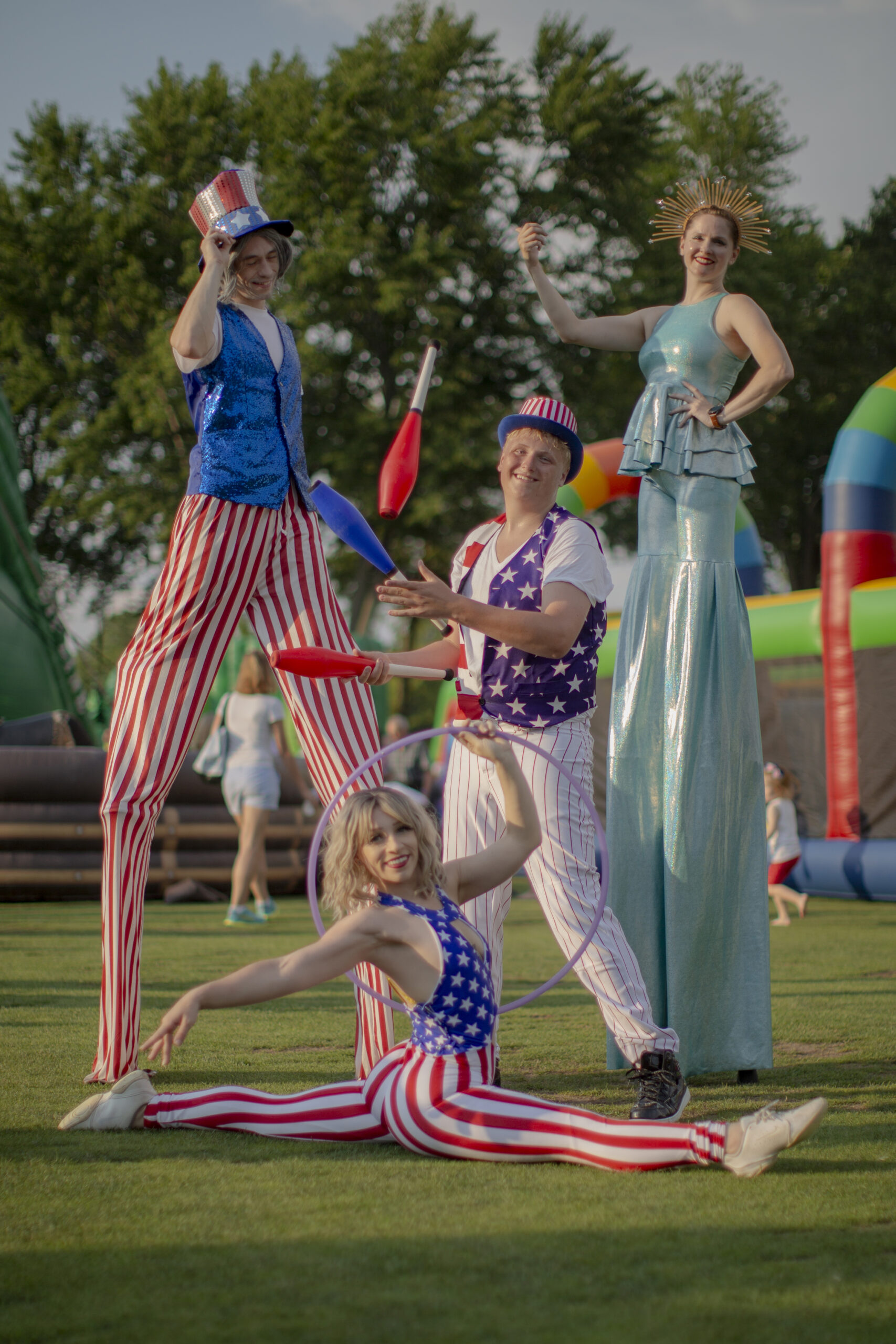 Patriotic stilt-walkers and acrobats outdoors