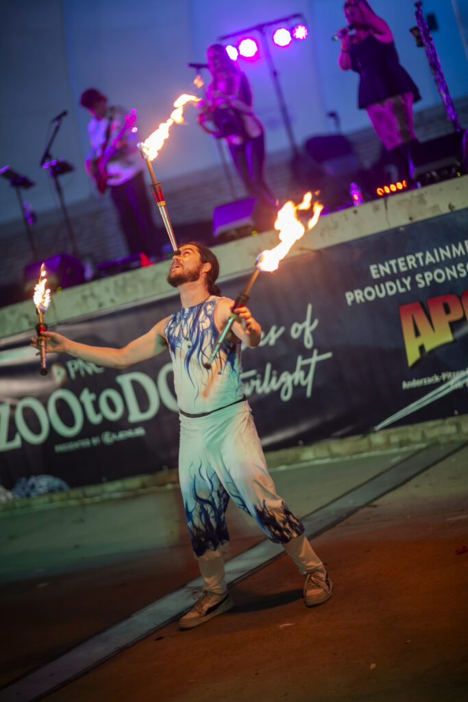 Fire juggler balancing torch in mouth