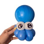 Blue balloon octopus held in a hand.