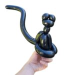 Black balloon animal resembling a cat.