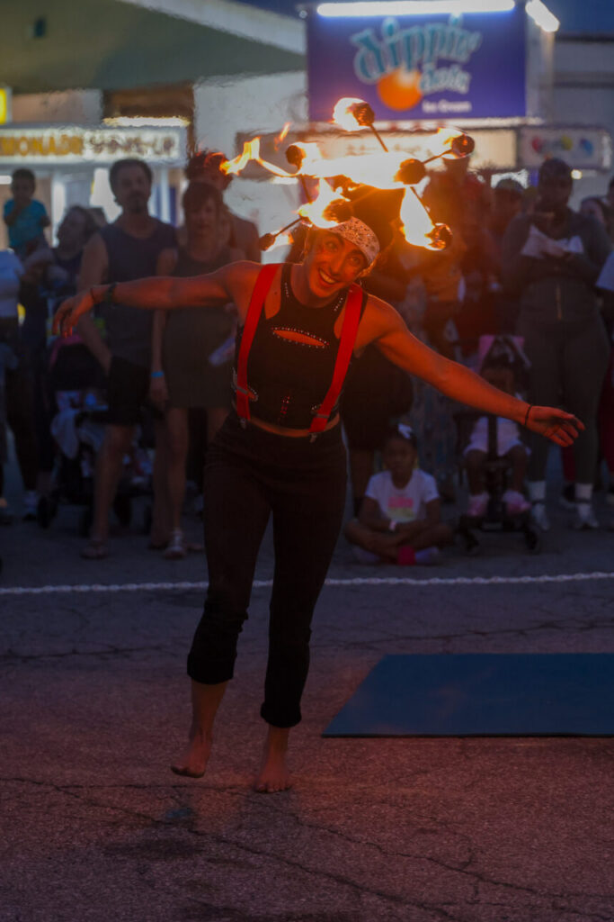 Sophia K performing with fire staff